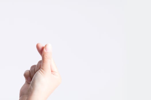 Close-up image of a symbol from a fingertip to be Love signs in Korean style called mini heart or little heart. photo
