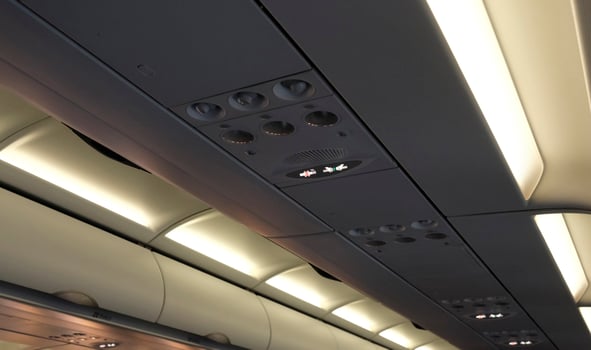 Overhead panel with lights and ventilation on an airplane photo