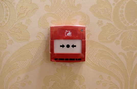 Fire alarm mounted on a wall in a hotel photo
