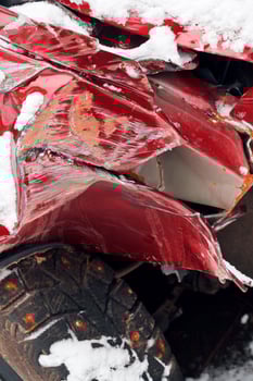broken fender of car after winter traffic accident photo