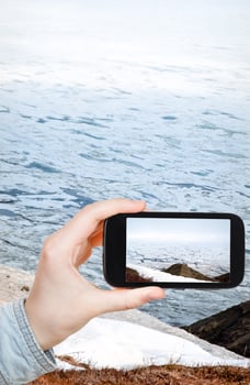 tourist taking photo of ice floes in Bering Sea