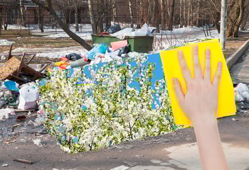hand deletes urban trash by yellow cloth photo