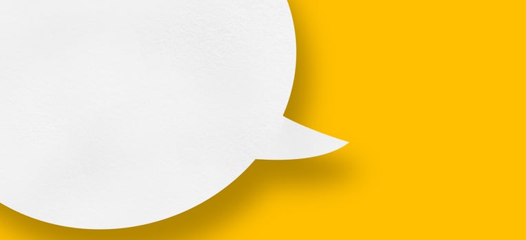 white paper speech bubble on yellow background photo