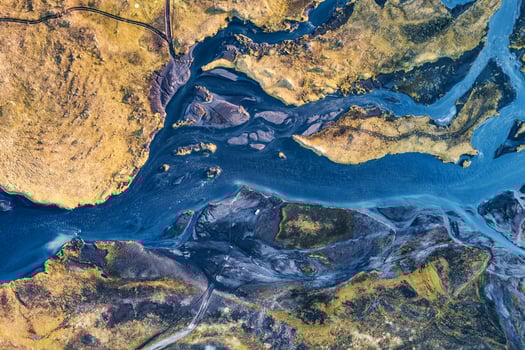 Abstract blue glacier rivers pattern flowing through volcanic moss field in Icelandic highlands on summer photo