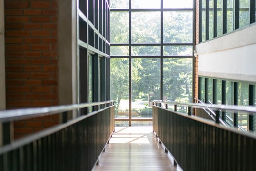 wooden slope walkway in the library with the window light from outside. photo