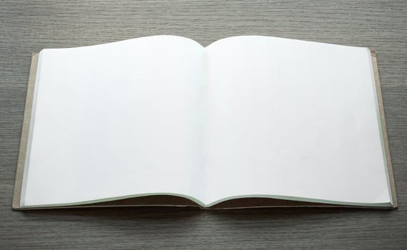 blank open book on dark wood background photo