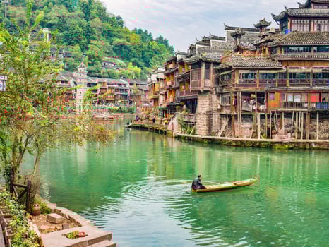 Unacquainted local chinese people on the boat in fenghuang old town.phoenix ancient town or Fenghuang County is a county of Hunan Province, China photo