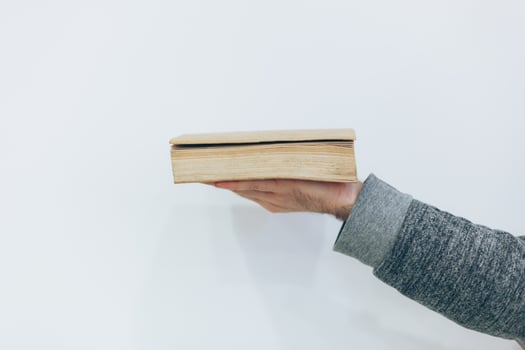 Man holding close old paper book photo