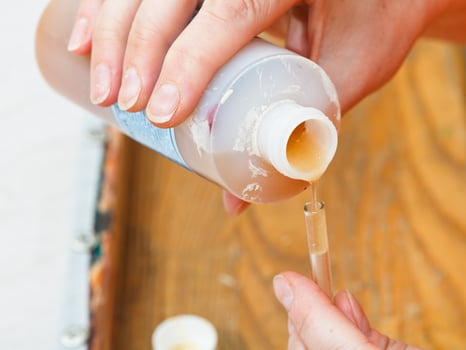 pouring of water based resist in glass tube photo