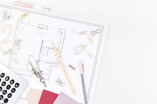 Interior designer table workplace with house plan photo