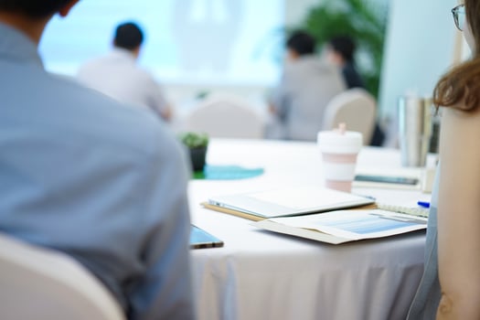 Man and Woman listen to speaker in front of hall in business seminar course. photo