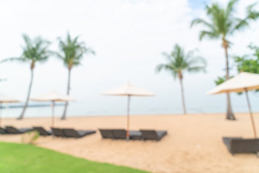 abstract blur beach chair on beach with ocean sea for background photo