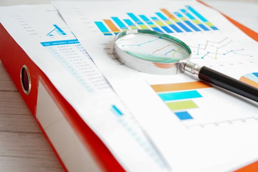 Magnifying glass on charts graphs paper. Financial development, Banking Account, Statistics, Investment Analytic research data economy. photo