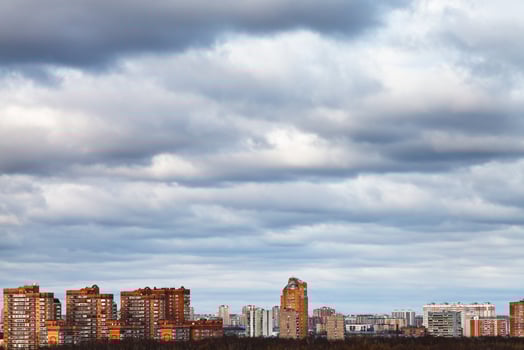 sky with blue clouds over urban houses photo