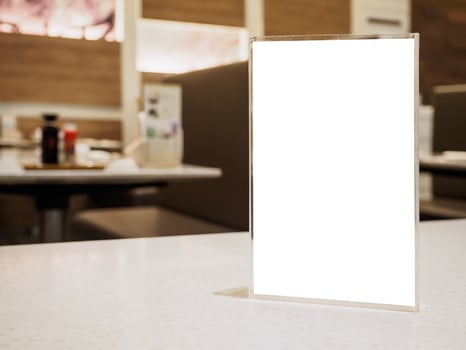 Mock up menu frame on table in the cafe restaurant photo