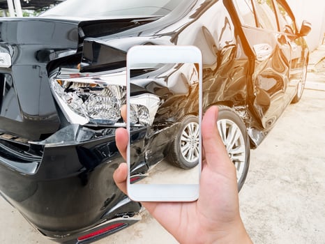 female hold mobile smartphone photographing car accident photo