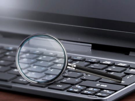 laptop computer with magnifying glass search concept photo