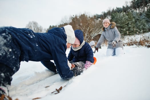 Mother playing with children in winter nature. Outdoors in snow. photo