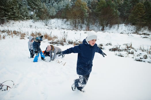 Mother playing with children in winter nature. Outdoors in snow. photo