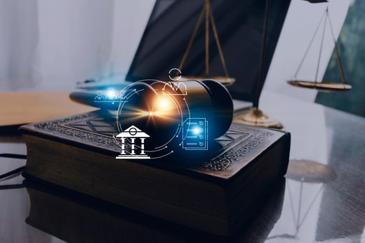 Justice and law concept.Male judge in a courtroom with the gavel, working with, computer and docking keyboard, eyeglasses, on table in morning light photo