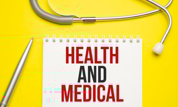 Health and Medical words on notepad and stethoscope photo