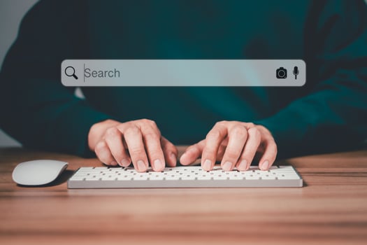 Freelancer's hand using a computer keyboard to search for information, job search. Business ideas for applying search to your website. photo