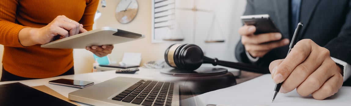Business and lawyers discussing contract papers with brass scale on desk in office. Law, legal services, advice, justice and law concept picture with film grain effect photo