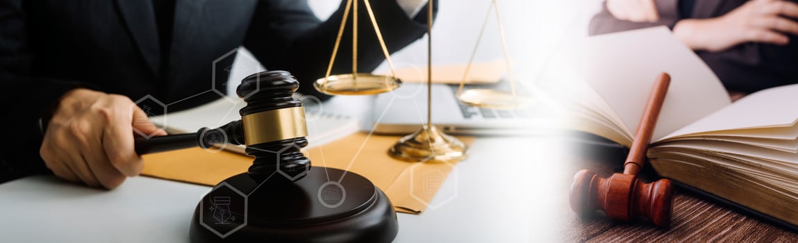 Justice and law concept.Male judge in a courtroom with the gavel, working with, computer and docking keyboard, eyeglasses, on table in morning light photo