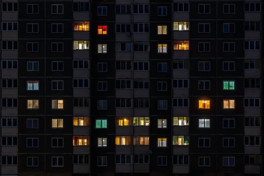 flat night panorama of multicolor smile face light in windows of multistory buildings photo