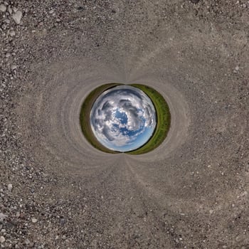 blue sphere little planet inside gravel road background. photo