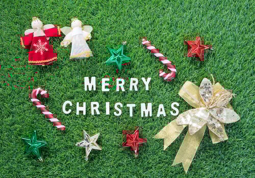 Christmas alphabet and decoration on green grass photo