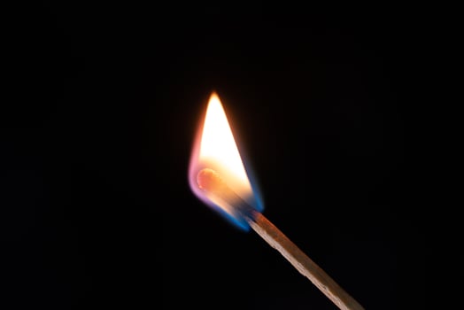 Smoke from burning matchsticks on a black background photo