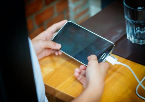 boy's hands holding smart phone photo