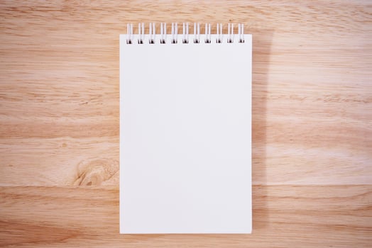 Notepad on the wooden desk table photo