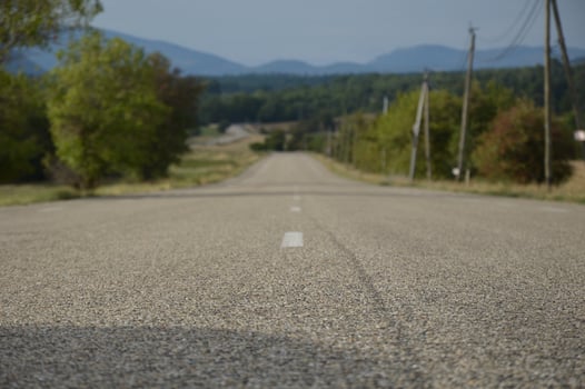 Long asphalt road in the countryside, France photo