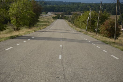 Long asphalt road in the countryside, France photo