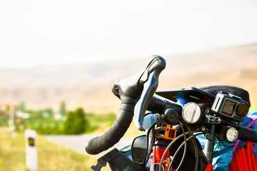 Close up touring bicycle stand on scenic gravel road in nature countryside. Fully loaded touring machine with copy space background photo