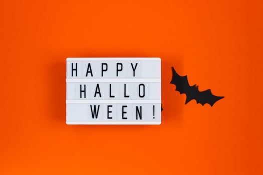 Halloween concept. Festive decorations. Bats on orange background. photo