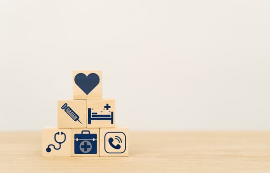 Health Insurance Concept,wood cube stacking with icon healthcare medical on wood background with copy space photo
