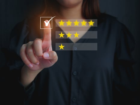 Customer satisfaction concept, Woman rating the product's satisfaction give it 5 rating stars. photo