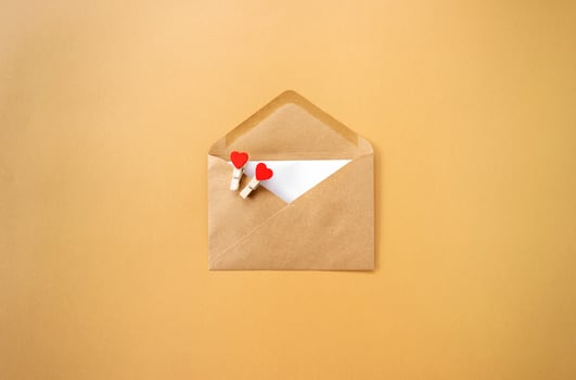 A brown envelope with red hearts in it for Valentines Day photo