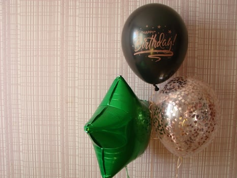 Blue balloon with words HAPPY BIRTHDAY on yellow background, space for text photo