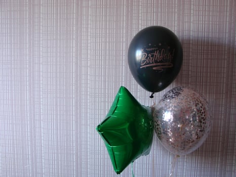 Blue balloon with words HAPPY BIRTHDAY on yellow background, space for text photo