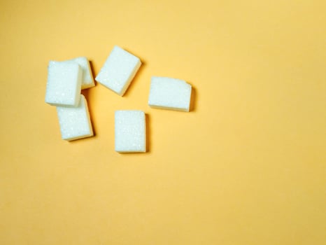 Sugar lumps on a yellow background. photo