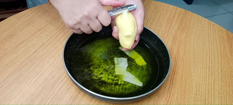 Potato Peels in Oil for making Process of Potato Chips, Aalu Chips photo