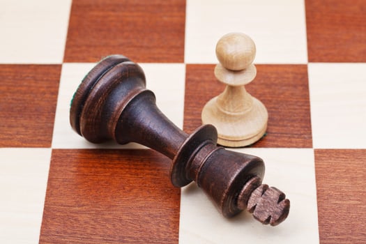 standing and fallen chess king and pawn photo