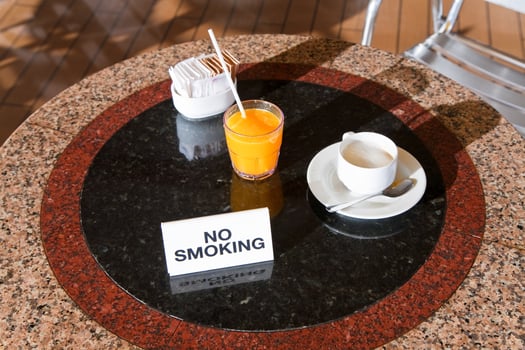 fresh orange juice and cappuccino on no smoking table photo