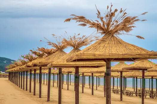 Beauty wooden umbrellas of empty sandy beach photo