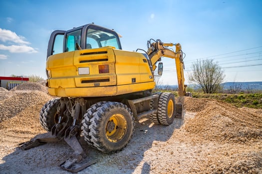 Rest, yellow excavator with shovel at construction site. Horizontal view photo