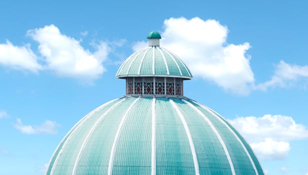 Green mosque roof on blue sky background photo